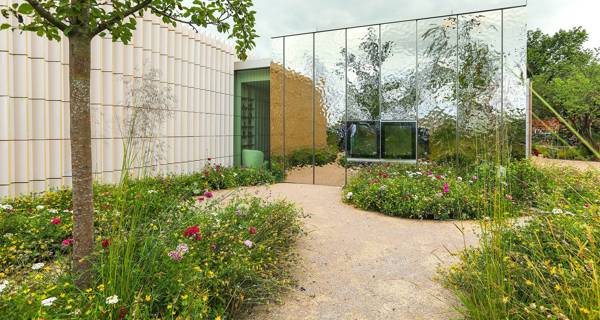 The garden at Maggie’s Southampton, filled with lush greenery, perennials, and trees such as birch, Scots pine, and rowan, creating a tranquil environment